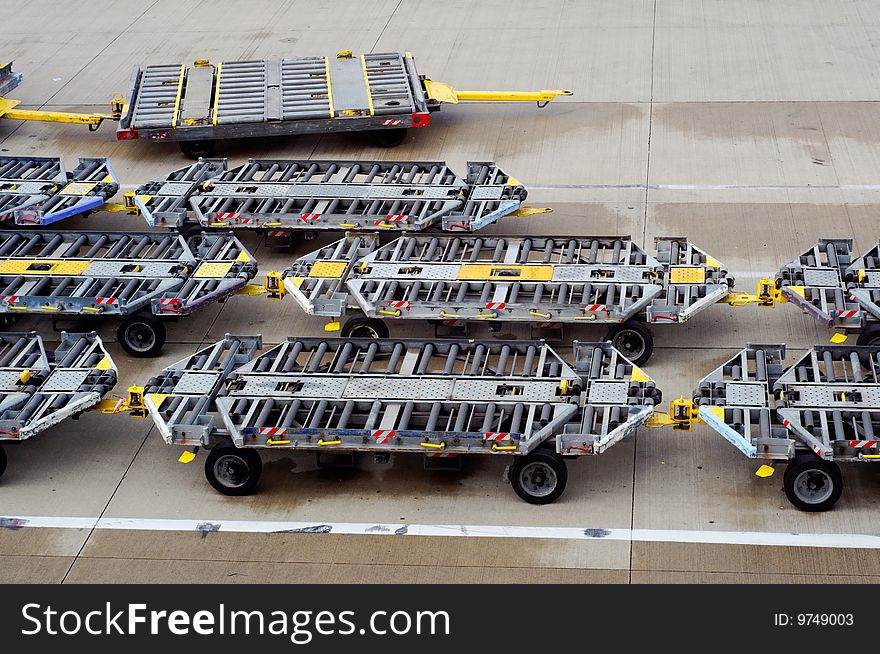 Rows of pallet dollys in an airfield