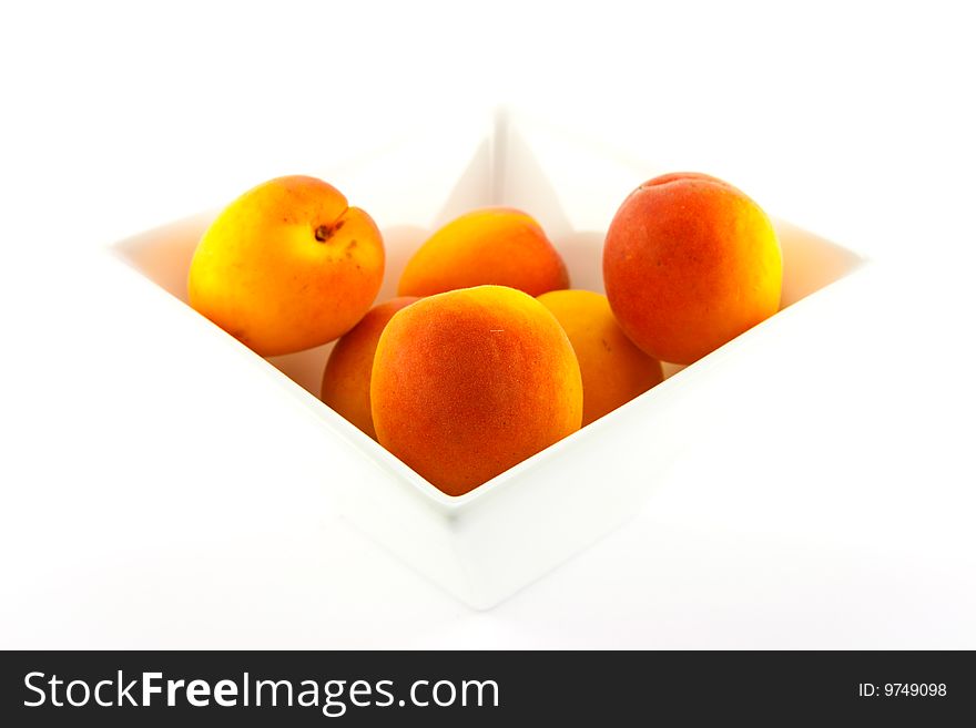 Bowl of apricots on a white background with clipping path