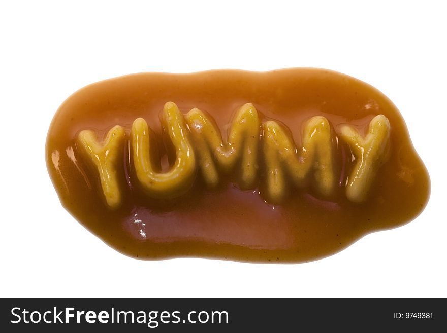 The word yummy spelled out in alphabet spaghetti pasta shapes, with tomato sauce, isolated on a white background. The word yummy spelled out in alphabet spaghetti pasta shapes, with tomato sauce, isolated on a white background.