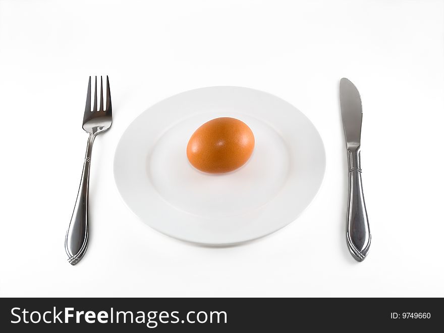 The egg lays on a white plate