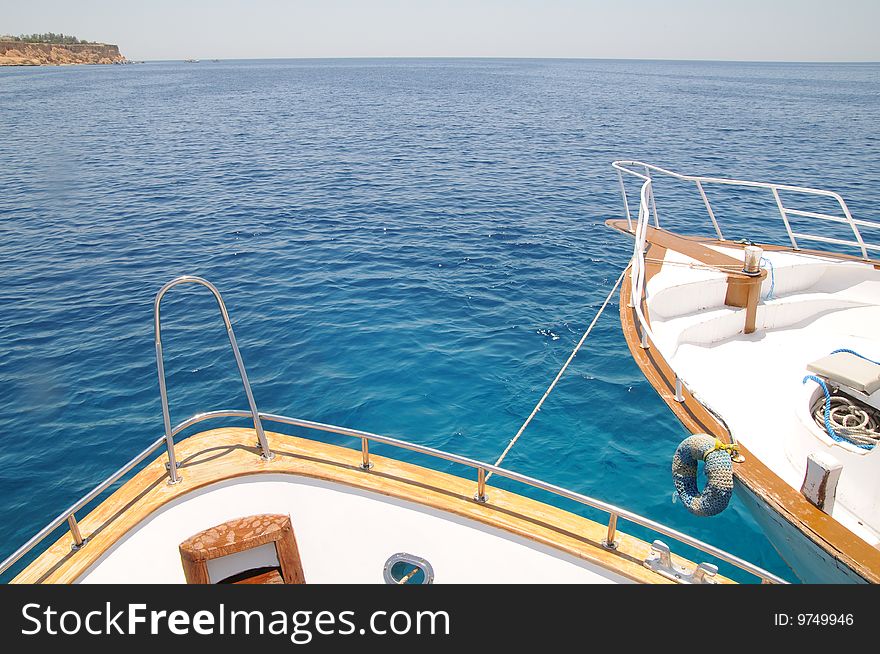Two yachts are moored with each other in the red sea. Two yachts are moored with each other in the red sea