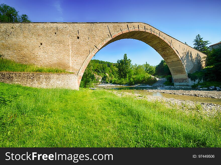 River under Alidosi Bridge, Renaissance masterpiece of civil engineering with donkey back structure, one of wonders of Italy