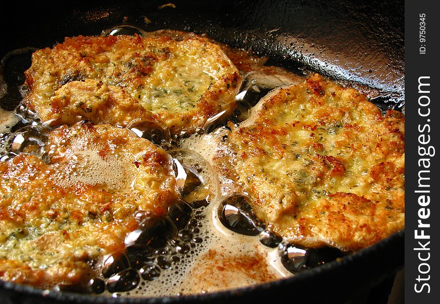 Cooking viennese schnitzel in a pan. Cooking viennese schnitzel in a pan.