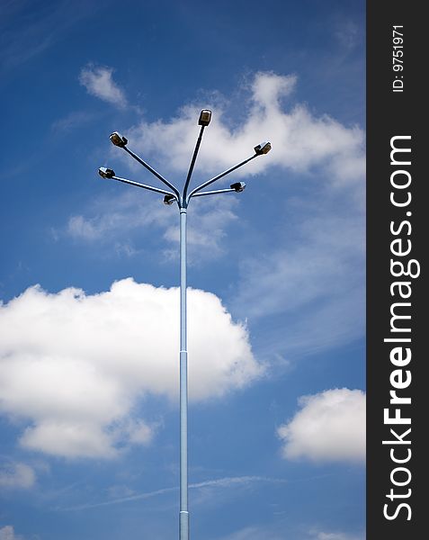 Electric pylon with bulbs and blue sky with clouds. Electric pylon with bulbs and blue sky with clouds.