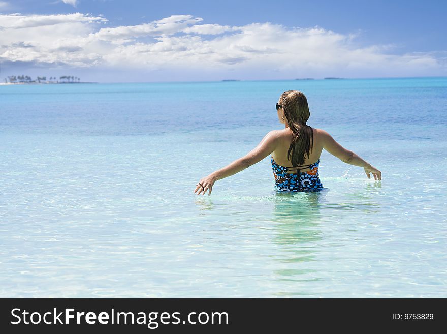 A woman walks through the warm Caribbean Ocean. Ahhh, this is beautiful, take me on vacation!. A woman walks through the warm Caribbean Ocean. Ahhh, this is beautiful, take me on vacation!