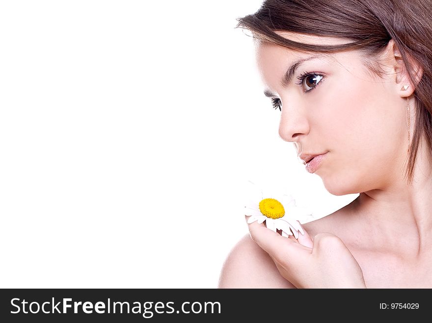 Close-up woman face with yellow camomile on a white background