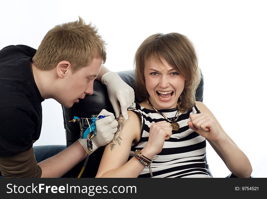 A man drawing tatoo pictures on woman's arm. A man drawing tatoo pictures on woman's arm