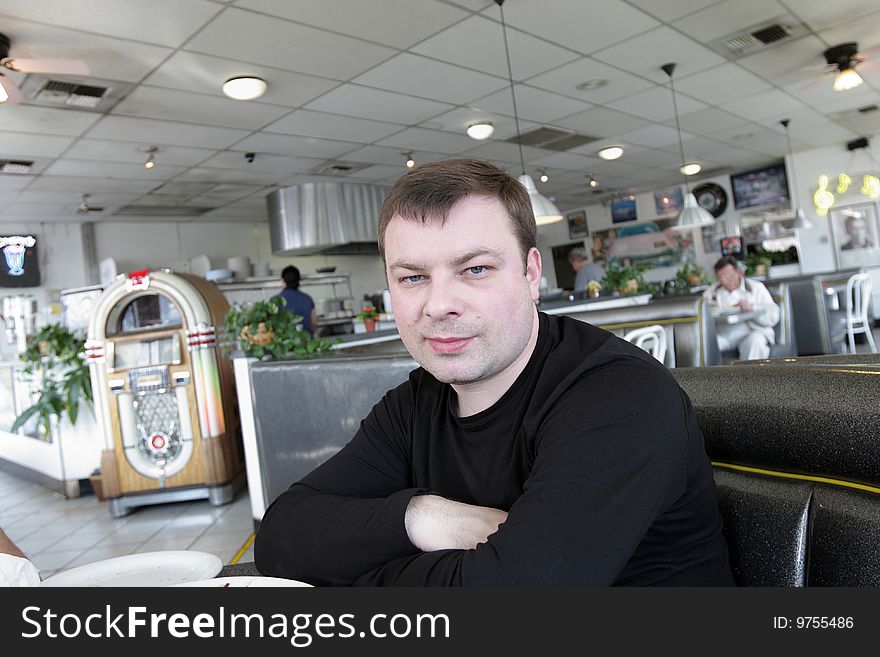 The man waits a breakfast in american snack bar