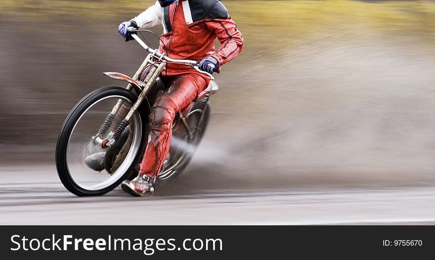 Motorcycle speedway rider on wet road