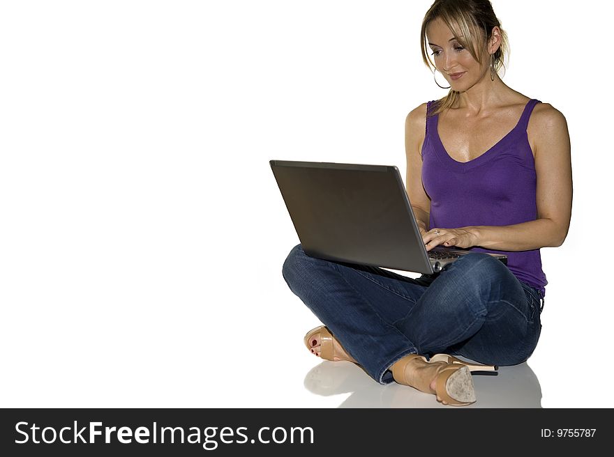 Young attractive woman in tshir blue jeans on professional laptop computer, on white backdrop. Young attractive woman in tshir blue jeans on professional laptop computer, on white backdrop
