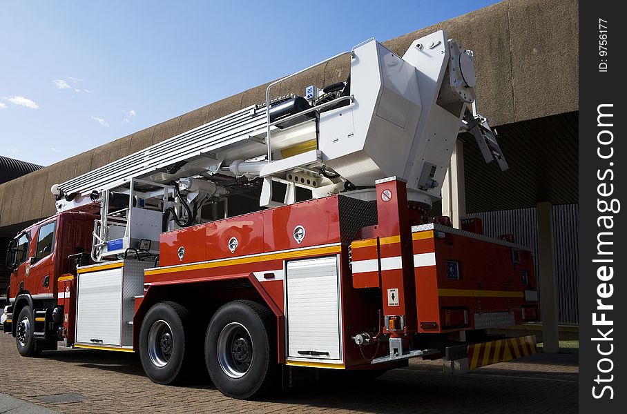 Red emergency vehicle or fire engine taken from behind at angle. Red emergency vehicle or fire engine taken from behind at angle.