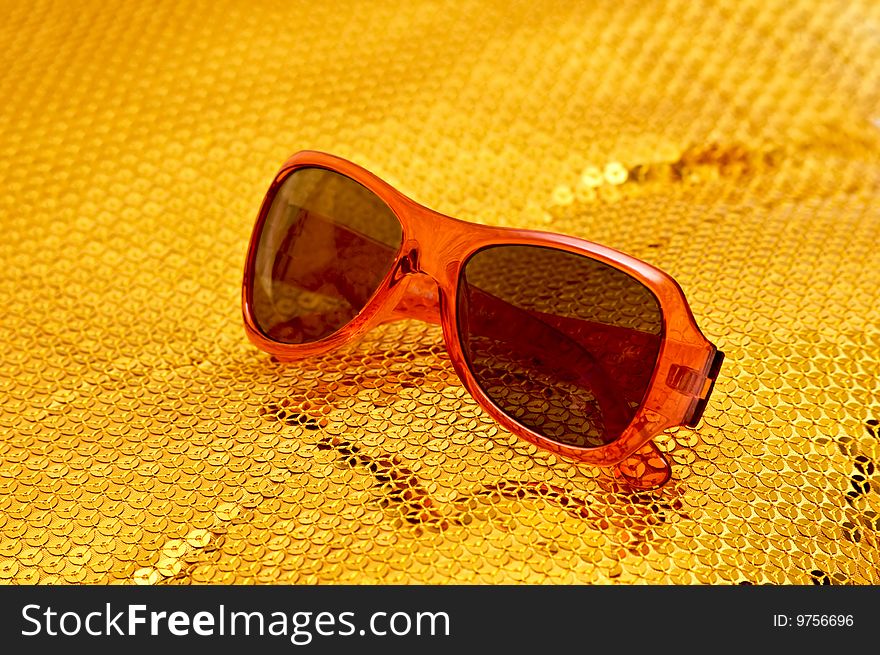 Photo of fashion sunglasses on sparkling pattern