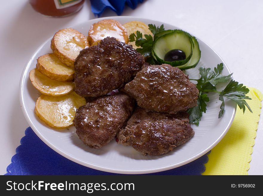 Aromatic chops with baked potatoes and green. Aromatic chops with baked potatoes and green