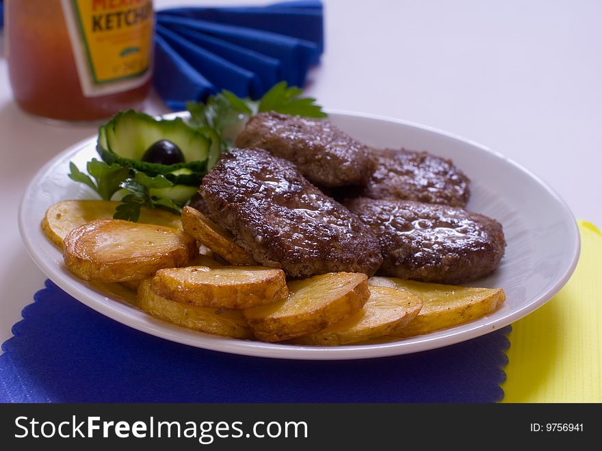 Aromatic chops with baked potatoes and green. Aromatic chops with baked potatoes and green