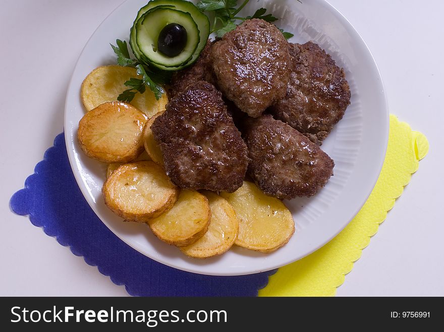 Aromatic chops with baked potatoes and green. Aromatic chops with baked potatoes and green