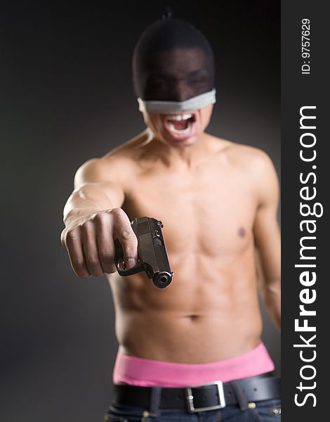 The aggressive robber with a pistol in a hand. The aggressive robber with a pistol in a hand