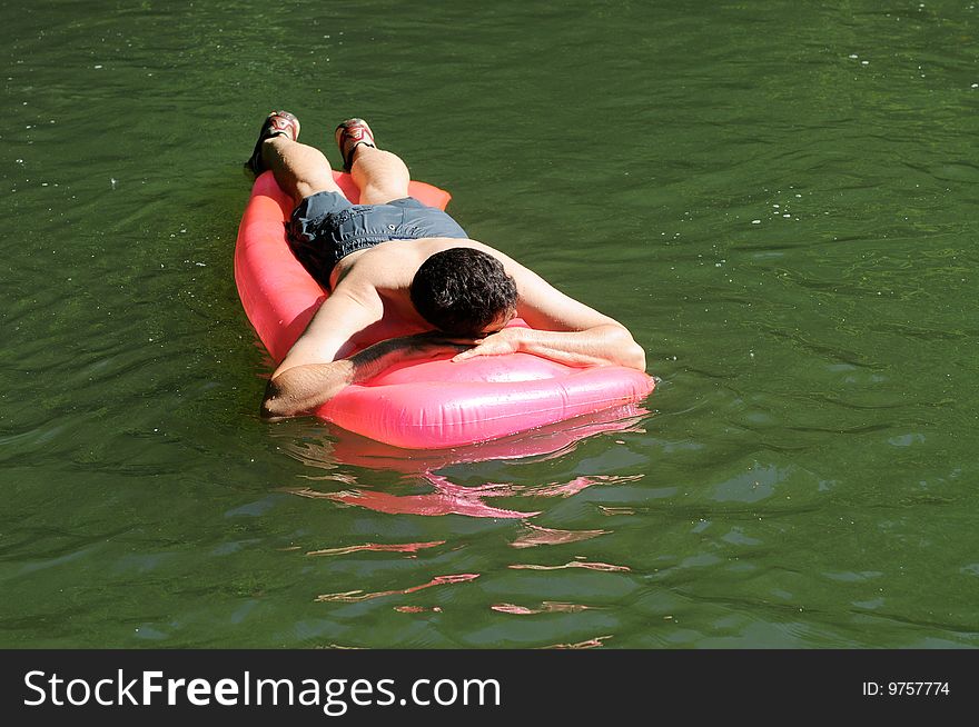 Man Relaxing On Inflatable