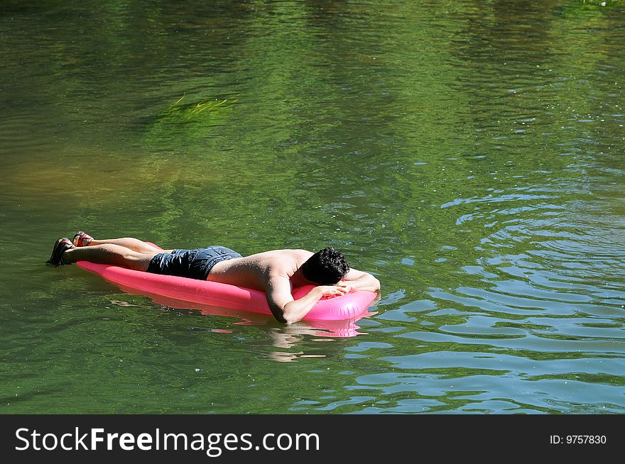 Man on an inflatable on river. Man on an inflatable on river