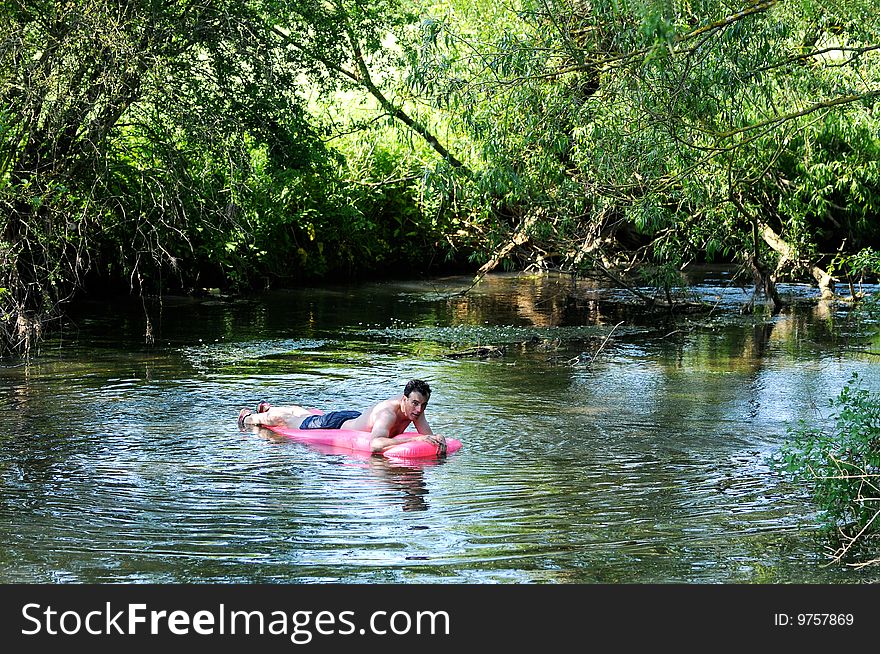 Portrait of man on inflatable on river. Portrait of man on inflatable on river