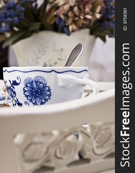 Cup of english tea served in white blue ceramics