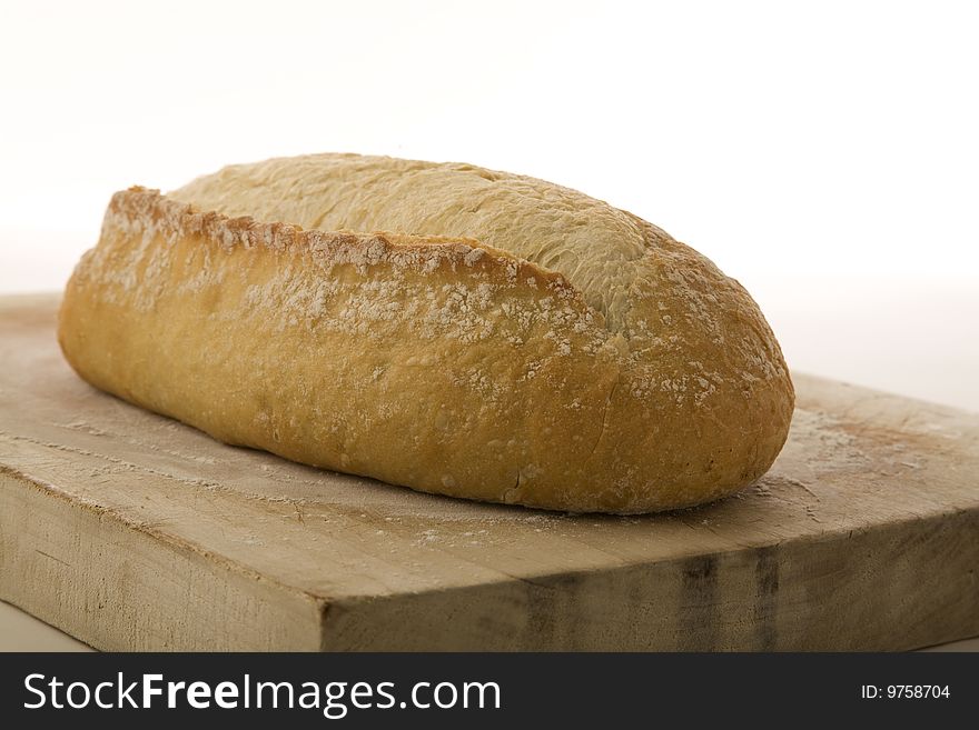 Italian artisan bread on a cutting board. Italian artisan bread on a cutting board.