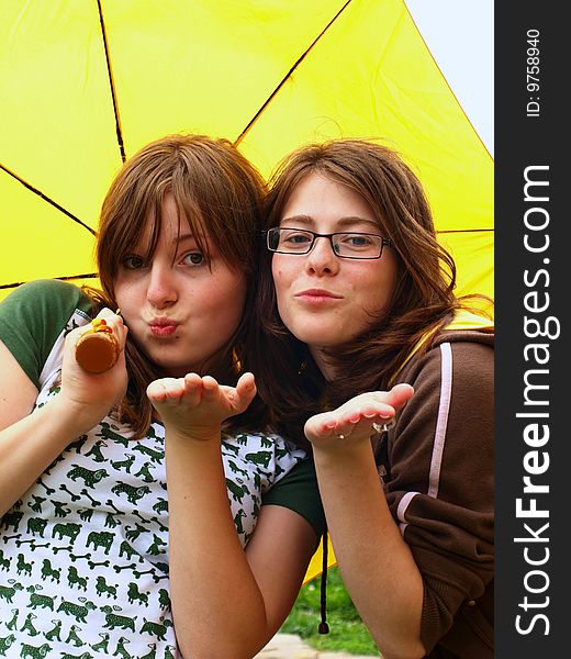 Teenager girls with yellow umbrella. Teenager girls with yellow umbrella