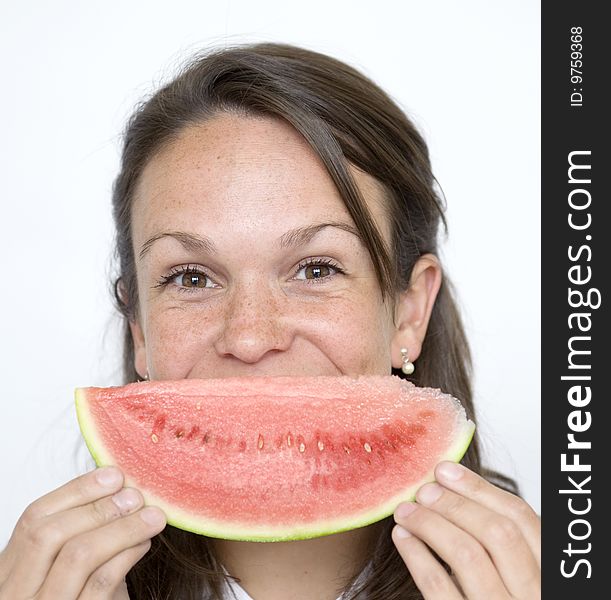 Pretty Brunette lady holds melon slice infront of face. Pretty Brunette lady holds melon slice infront of face