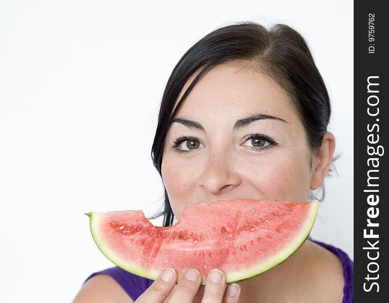 Pretty Brunette lady holds melon slice infront of face. Pretty Brunette lady holds melon slice infront of face