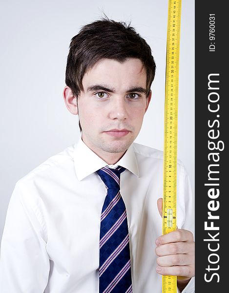 Young office worker holds a yellow ruler. Young office worker holds a yellow ruler