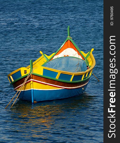 Colorful Luzzu fishing boat in harbour of fishing village Marsaxlokk, Malta. Colorful Luzzu fishing boat in harbour of fishing village Marsaxlokk, Malta