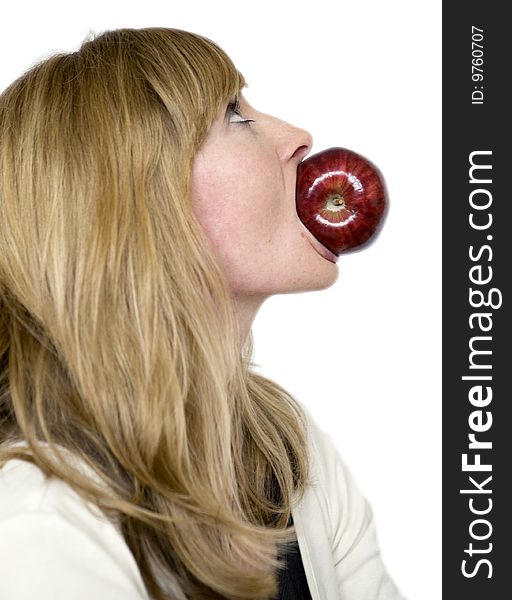 Pretty Blonde girl holds red apple in mouth. Pretty Blonde girl holds red apple in mouth