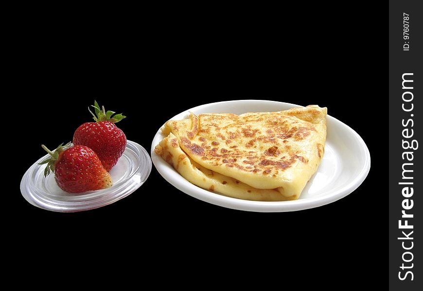 Close up pancake and strawberries on black background