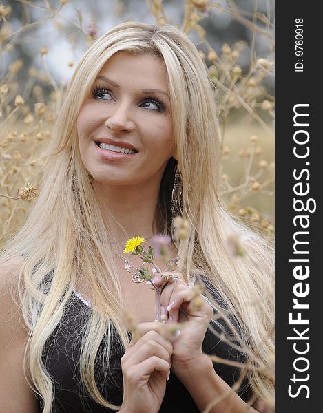 A young lady enjoying a spring afternoon in a field. A young lady enjoying a spring afternoon in a field