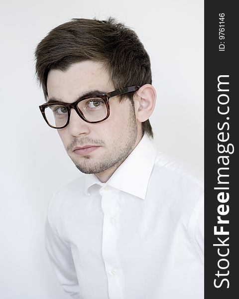 Young stylish man wears glasses and white shirt. Young stylish man wears glasses and white shirt