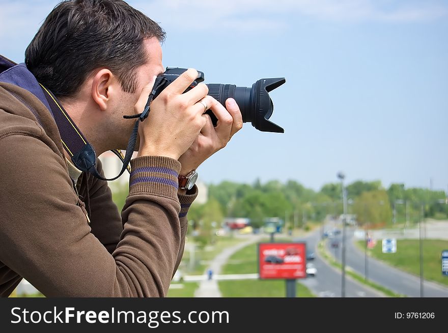 Male photographer waiting for a nice shoot.