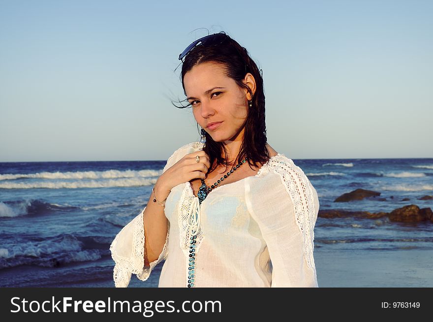 Portrait of young trendy female posing on tropical beach background. Portrait of young trendy female posing on tropical beach background