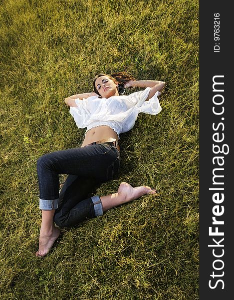 Portrait of young female beauty lying on the grass. Portrait of young female beauty lying on the grass