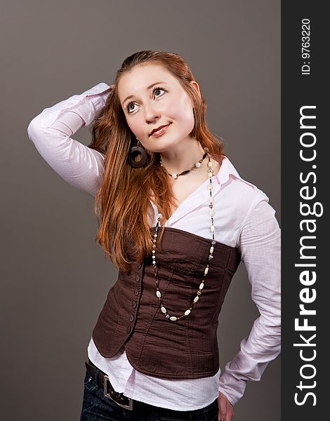 Red haired girl with lifted hands