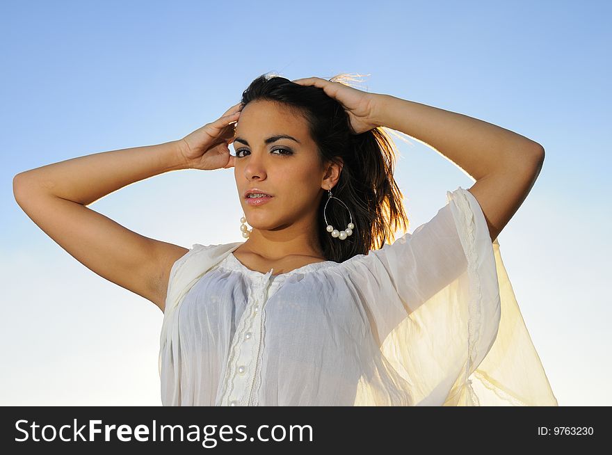 Portrait of young fresh beauty posing against blue sky. Portrait of young fresh beauty posing against blue sky