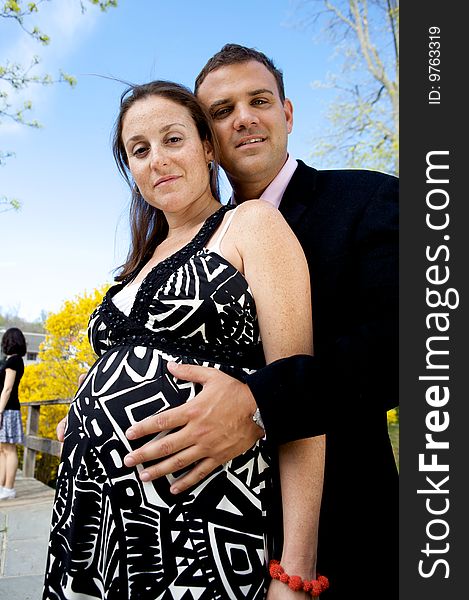 Pregnant Couple with a man's hands on her belly