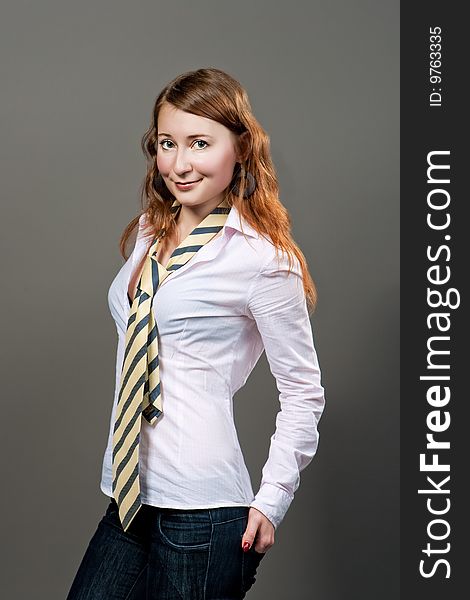 Red haired girl in striped tie isolated. Red haired girl in striped tie isolated