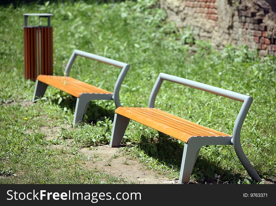Two benches on green grass outside
