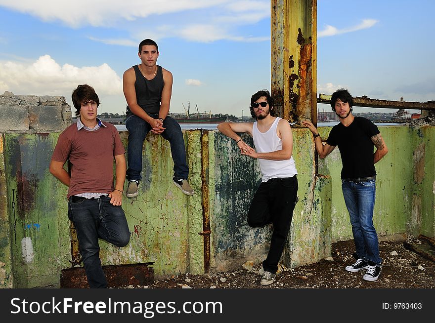 Portrait of casual team of friends posing on grunge urban scene. Portrait of casual team of friends posing on grunge urban scene