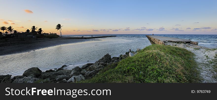 A view of tropical beach landscape at sunset with pier. A view of tropical beach landscape at sunset with pier