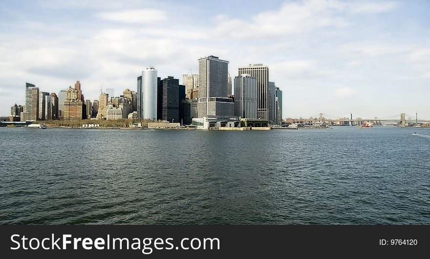 View from the harbor of lower Manhattan Island and East River with both Brooklyn and Manhattan Bridges. View from the harbor of lower Manhattan Island and East River with both Brooklyn and Manhattan Bridges