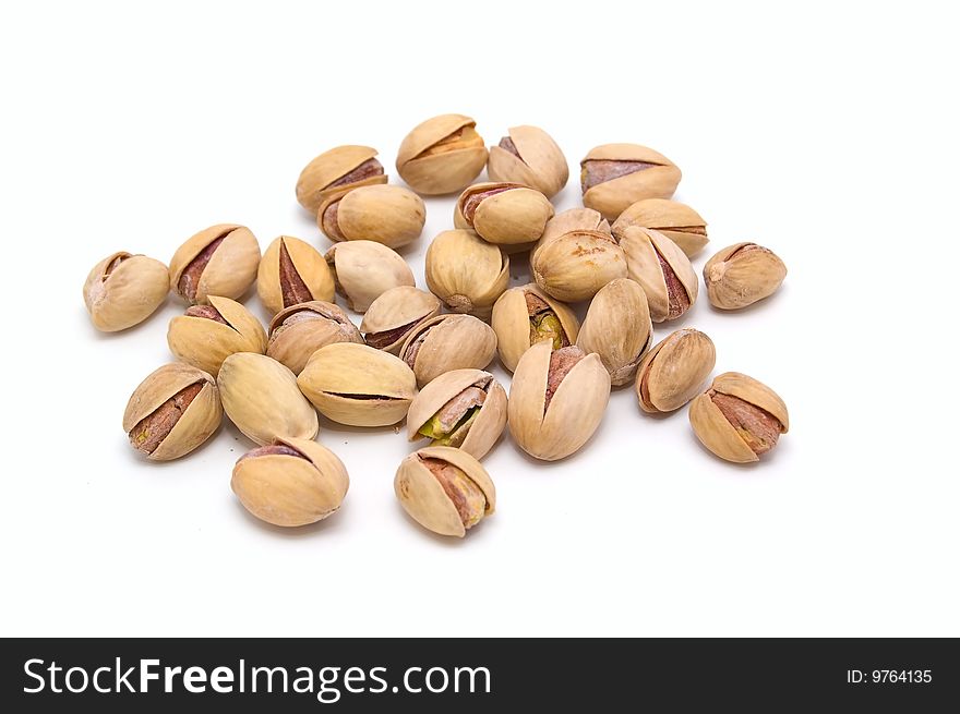 Salted pistachio nuts on a white background. Close-up. Macro. Salted pistachio nuts on a white background. Close-up. Macro.