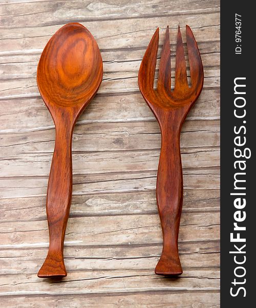 Wooden spoon and fork on vintaged wood background