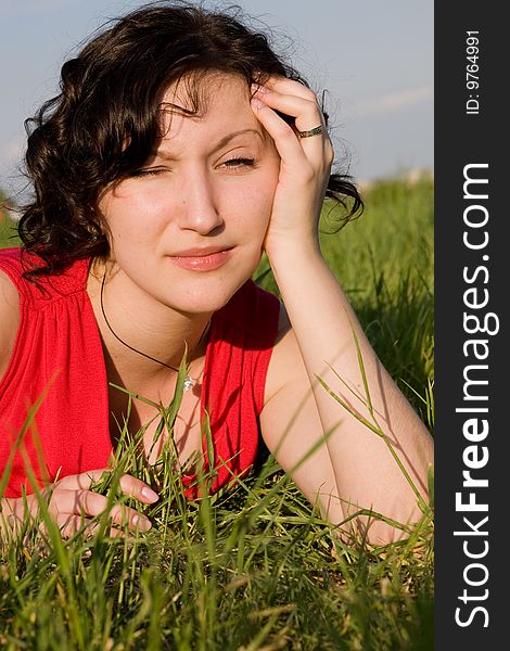 Young women resting on the meadow (summer)