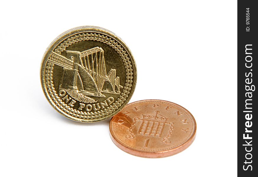 Close-up of UK pound and penny on white background