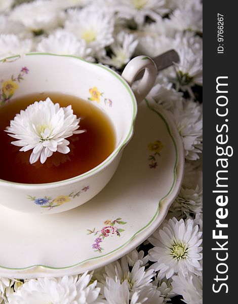 Cup of tea in flowers surrounding